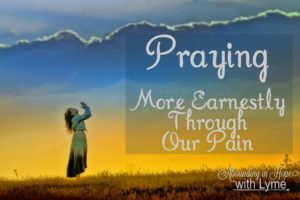 Woman standing outside with her hands up in worship and prayer with clouds and a beautiful golden skylight