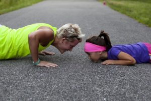 Mom and Daughter on the pavement doing pushups